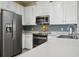 This kitchen features stainless steel appliances, and light countertops, offering a stylish and functional cooking space at 1022 Saint Ives Ct, Mount Dora, FL 32757