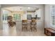 Modern kitchen featuring white cabinets, stainless steel appliances, and bar seating at 1022 Saint Ives Ct, Mount Dora, FL 32757