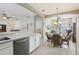 Contemporary kitchen with stainless steel dishwasher that opens to the dining area at 1022 Saint Ives Ct, Mount Dora, FL 32757
