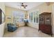 Cozy living room featuring two bright windows with plantation shutters and a curio cabinet to add charm at 1022 Saint Ives Ct, Mount Dora, FL 32757