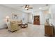 Inviting living room with light wood floors, ceiling fan, and comfortable seating at 1022 Saint Ives Ct, Mount Dora, FL 32757