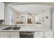 View from the kitchen into the light filled open-concept living room, featuring white walls, and bright natural light at 1022 Saint Ives Ct, Mount Dora, FL 32757