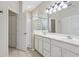 Brightly lit ensuite bath features dual sinks, walk-in shower, and ample storage for a spa-like experience at 1022 Saint Ives Ct, Mount Dora, FL 32757