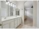 Ensuite bath featuring dual sinks, generous counter space, and a seamless transition to the main bedroom at 1022 Saint Ives Ct, Mount Dora, FL 32757