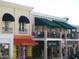 Charming shops with awnings, balconies, and storefronts, creating a vibrant and inviting street scene at 1022 Saint Ives Ct, Mount Dora, FL 32757