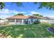 Well-maintained backyard with a screen porch and manicured lawn at 10257 Dovehill Ln, Clermont, FL 34711