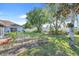 Lush backyard with manicured gardens and mature trees at 10257 Dovehill Ln, Clermont, FL 34711