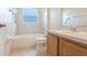 Bathroom with a shower and tub combo, tile flooring and a single vanity at 10257 Dovehill Ln, Clermont, FL 34711