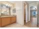 Bathroom featuring a single vanity, walk-in closet, and doorway to bedroom at 10257 Dovehill Ln, Clermont, FL 34711