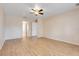 Spacious bedroom with wood-look tile flooring and ceiling fan at 10257 Dovehill Ln, Clermont, FL 34711