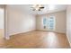 Large bedroom featuring wood-look tile flooring and private balcony access at 10257 Dovehill Ln, Clermont, FL 34711
