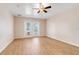Bedroom with wood-look tile floors, ceiling fan, and French doors leading to an outdoor space at 10257 Dovehill Ln, Clermont, FL 34711