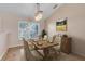 Cozy dining room featuring chandelier, wood table, and window at 10257 Dovehill Ln, Clermont, FL 34711