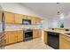Kitchen showcasing granite countertops, tile backsplash, modern appliances, and wood-look tile flooring at 10257 Dovehill Ln, Clermont, FL 34711