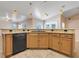 Kitchen with granite countertops, stainless steel dishwasher, and pendant lighting above the breakfast bar at 10257 Dovehill Ln, Clermont, FL 34711