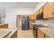 Kitchen with granite countertops, stainless steel appliances, and wood cabinets at 10257 Dovehill Ln, Clermont, FL 34711