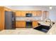 Updated kitchen showcasing granite countertops, modern appliances, and ample wood cabinetry at 10257 Dovehill Ln, Clermont, FL 34711