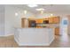 Kitchen island featuring granite countertops, pendant lighting, and modern appliances at 10257 Dovehill Ln, Clermont, FL 34711