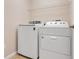 Bright laundry room with modern appliances and a shelf for extra storage at 10257 Dovehill Ln, Clermont, FL 34711