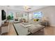 Bright living room features wood floors, stylish furniture, and lots of natural light at 10257 Dovehill Ln, Clermont, FL 34711