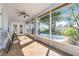 Covered back porch with access to the manicured backyard and ample seating at 10257 Dovehill Ln, Clermont, FL 34711
