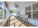 Enclosed back porch features brick floor and peaceful seating at 10257 Dovehill Ln, Clermont, FL 34711