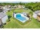 Aerial view of the community pool surrounded by lush landscaping and well-maintained townhomes at 1051 S Highland St # 4B, Mount Dora, FL 32757