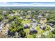 This aerial view features the community, a nearby golf course and surrounding wooded areas in a serene setting at 1051 S Highland St # 4B, Mount Dora, FL 32757