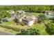 Aerial view showcases the townhome community, well-manicured lawns, mature trees, and ample parking at 1051 S Highland St # 4B, Mount Dora, FL 32757