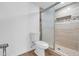 Bathroom featuring shower with mosaic tile and glass door at 1051 S Highland St # 4B, Mount Dora, FL 32757