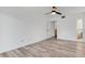 Bedroom features wood-look flooring, a ceiling fan, and access to the bathroom at 1051 S Highland St # 4B, Mount Dora, FL 32757