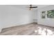 Bedroom with wood-look floors, ceiling fan, and built-in desk at 1051 S Highland St # 4B, Mount Dora, FL 32757