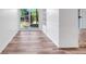 Versatile bonus room featuring wood floors, built-in shelving, and sliding glass doors to the exterior at 1051 S Highland St # 4B, Mount Dora, FL 32757