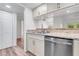Well-equipped kitchen with stainless steel dishwasher and light countertops, great for cooking at 1051 S Highland St # 4B, Mount Dora, FL 32757