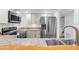 Modern kitchen with stainless steel fridge and appliances, sleek countertop and plenty of storage at 1051 S Highland St # 4B, Mount Dora, FL 32757
