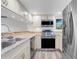 Modern kitchen featuring stainless steel appliances, recessed lighting, and bright countertops at 1051 S Highland St # 4B, Mount Dora, FL 32757