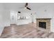 Open living area with sleek wood floors, fireplace, breakfast bar, and view of the front door at 1051 S Highland St # 4B, Mount Dora, FL 32757