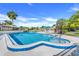 Community swimming pool with clear blue water, surrounded by lush greenery, offering a serene retreat at 1051 S Highland St # 4B, Mount Dora, FL 32757
