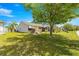 Spacious backyard showcases mature trees, lush green lawn, and a well-maintained landscape at 1089 Nash Loop, The Villages, FL 32162