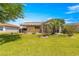Landscaped backyard with a covered patio area offers an ideal space for outdoor entertainment and relaxation at 1089 Nash Loop, The Villages, FL 32162