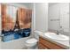 Bathroom featuring a Eiffel Tower themed shower curtain, sink, and toilet at 1089 Nash Loop, The Villages, FL 32162
