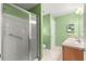 Bathroom with tiled walk-in shower, double sink vanity, and neutral color scheme at 1089 Nash Loop, The Villages, FL 32162