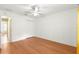 Cozy bedroom features laminate wood flooring, ceiling fan, and ample closet space at 1089 Nash Loop, The Villages, FL 32162