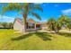 Well-manicured front yard with mature landscaping and a charming facade creates curb appeal at 1089 Nash Loop, The Villages, FL 32162