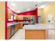 Bright kitchen featuring stainless steel appliances, ample counter space, and light wood cabinets at 1089 Nash Loop, The Villages, FL 32162