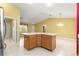 Open kitchen island with storage and adjacent living area with natural light through window at 1089 Nash Loop, The Villages, FL 32162