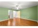 Spacious main bedroom with wood flooring, ceiling fan, and multiple closets at 1089 Nash Loop, The Villages, FL 32162