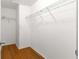 Empty walk-in closet with shelving and laminate flooring at 1089 Nash Loop, The Villages, FL 32162