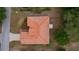 Aerial view showcasing the property's unique terracotta roof, driveway, landscaping, and surrounding neighborhood layout at 11497 Sw 82Nd Court Rd, Ocala, FL 34481