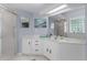 Modern bathroom with a frameless glass shower, ample lighting, and vanity space at 11497 Sw 82Nd Court Rd, Ocala, FL 34481